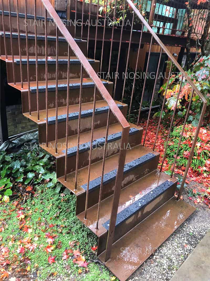 FRP stair nosing installation on checker plate Outdoor metal stair nosing with anti-slip surface and railing.