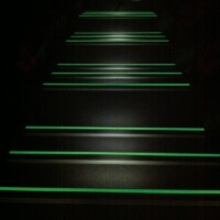 Illuminated stairs with glow in the dark nosing for enhanced safety in low light conditions. Glow in the dark stair nosing for safety and visibility.
